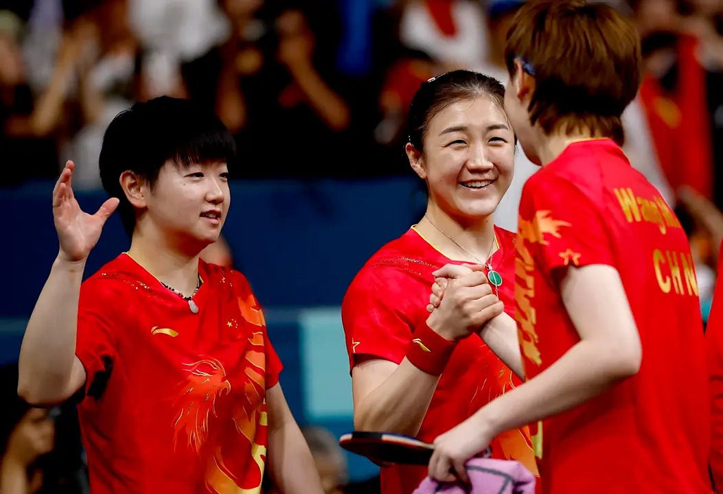 La  china Wang Manyu (d) celebra con sus compa&ntilde;eras Sun Yingsha (I) y Cheng Meng after la victoria ante Jap&oacute;n en la final en el South Paris Arena in Paris, Francia. EFE/EPA/YOAN VALAT